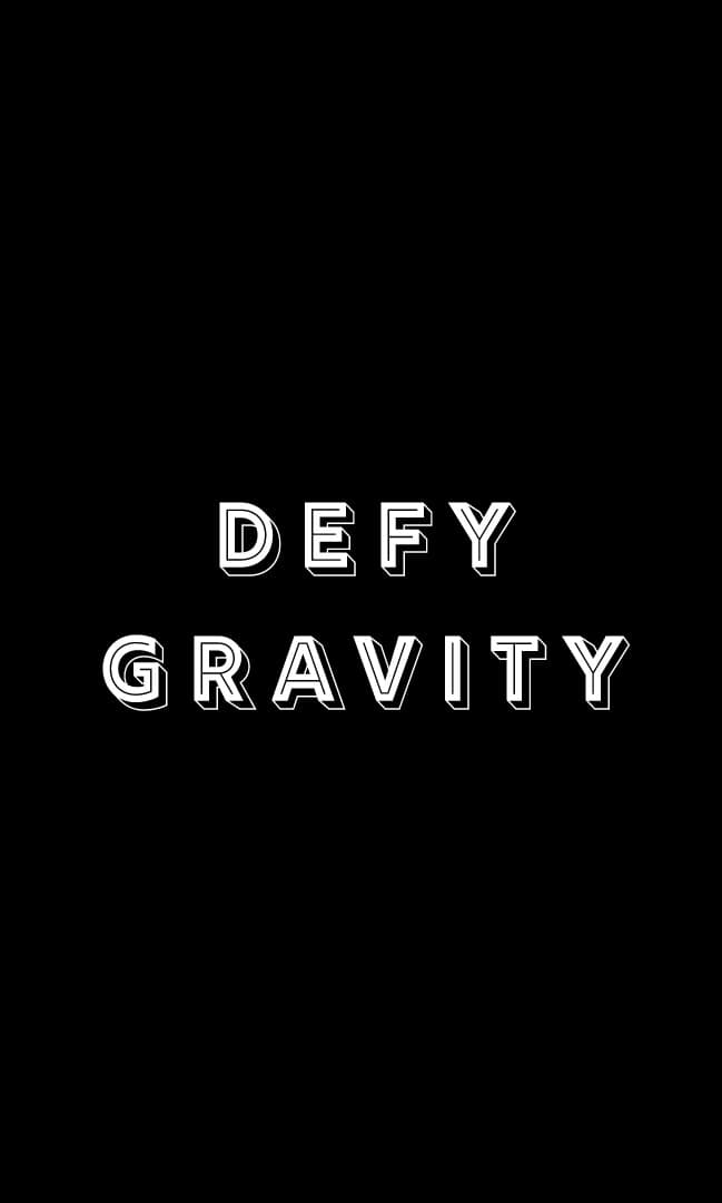 A digital card-face study: same black field, DEFY GRAVITY set in chunky 3D outlined display caps in two lines. The type leans on its outlines to glow off the ground.