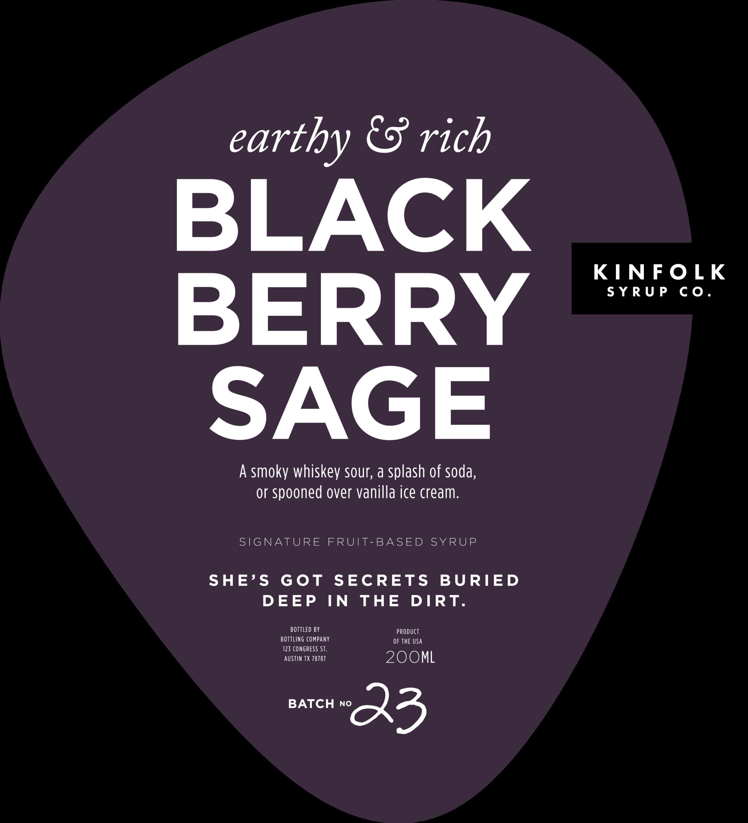 The Blackberry Sage label: deep wine-purple teardrop, 'earthy & rich' italic kicker, BLACK BERRY SAGE in chunky white display caps stacked across three lines, 'A smoky whiskey sour, a splash of soda, or spooned over vanilla ice cream' as the serving suggestion, and 'She's got secrets buried deep in the dirt' as the personality line.