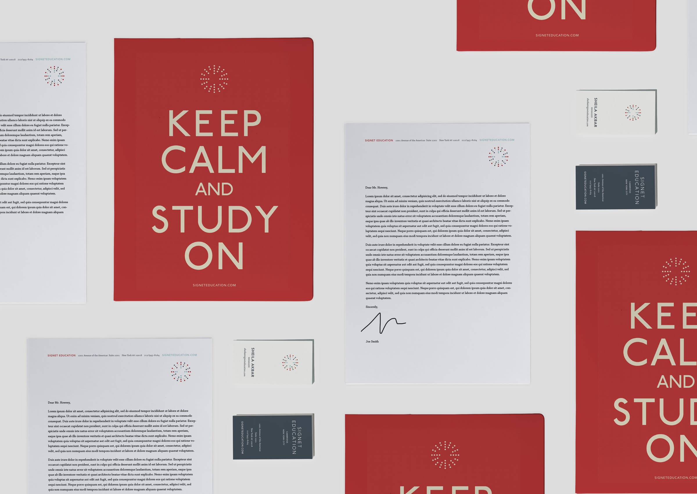 A flat lay of the Signet Education stationery package: red folder covers with KEEP CALM AND STUDY ON set in chunky cream display, letterheads with body copy and a small Signet mark at the top, navy and white business cards reading SIGNET EDUCATION CAMBRIDGE, all tiled across a clean grey surface.
